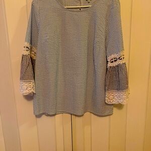 Cotton blend light blue/white top with bell sleeves with lace. Good condition.